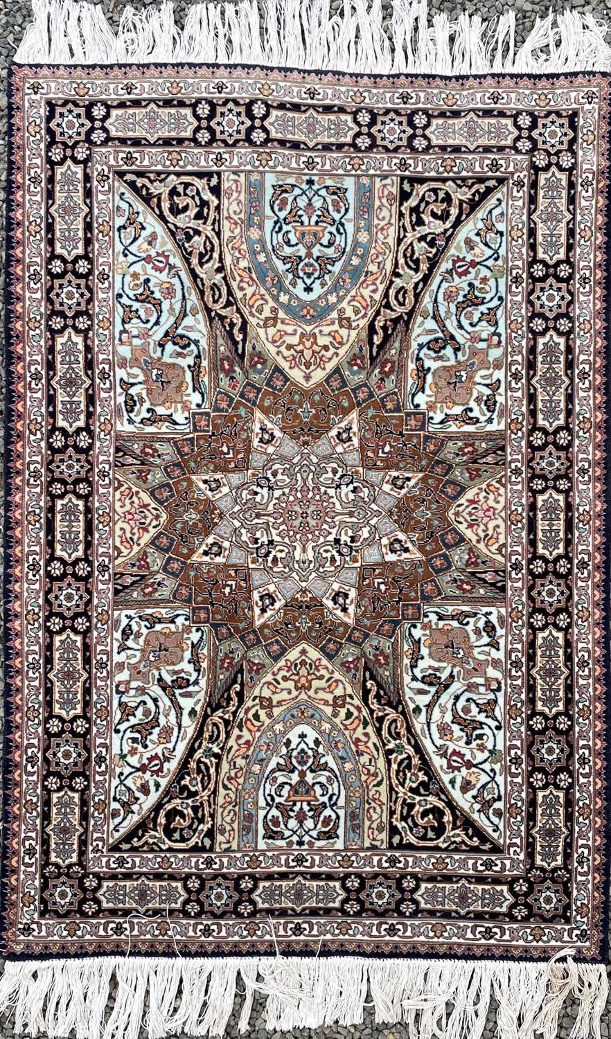 Lot 1247 - A Persian rug, the indigo field with a large...