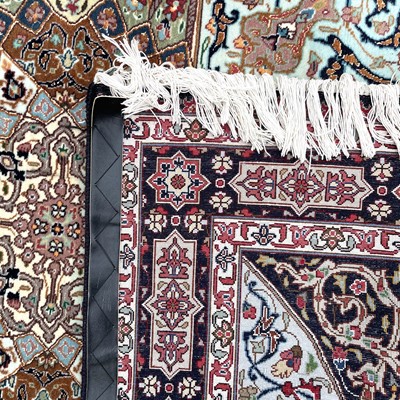 Lot 1247 - A Persian rug, the indigo field with a large...