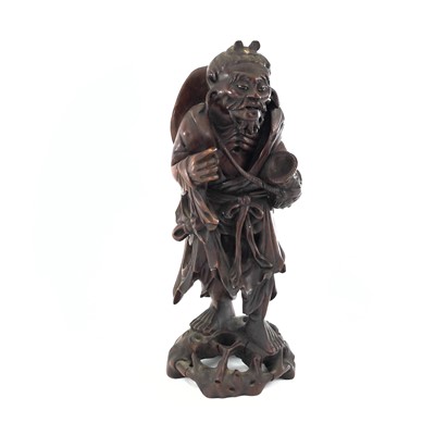 Lot 290 - A Chinese carved hardwood figure of a bearded...