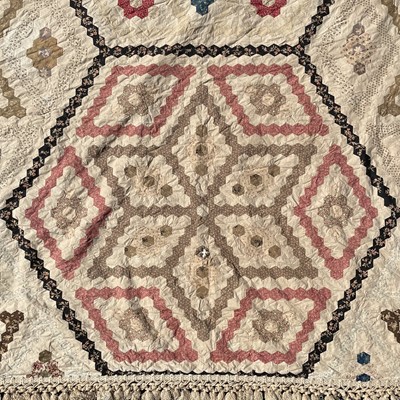 Lot 1609 - A Victorian patchwork quilt with hexagonal...