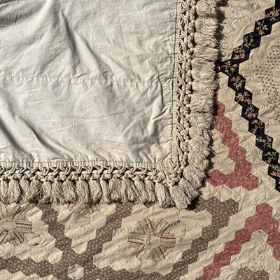 Lot 1609 - A Victorian patchwork quilt with hexagonal...