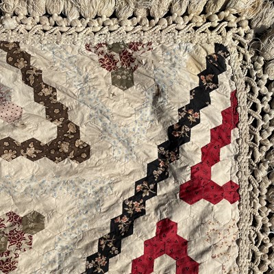 Lot 1609 - A Victorian patchwork quilt with hexagonal...