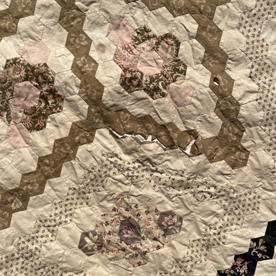 Lot 1609 - A Victorian patchwork quilt with hexagonal...