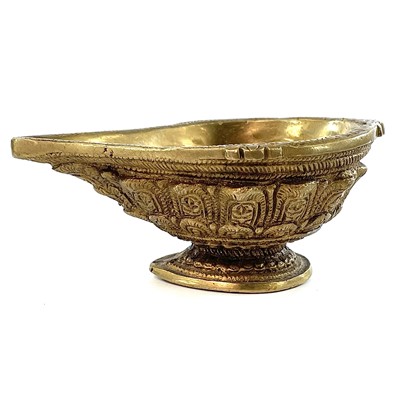 Lot 1001 - An Indian gilt metal oil lamp.