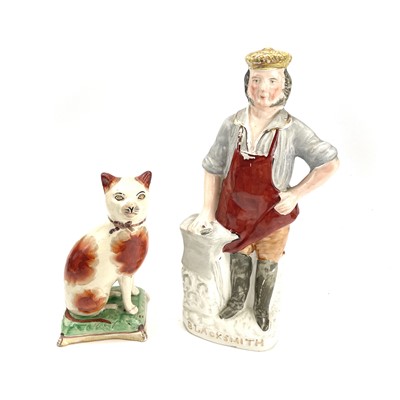 Lot 842 - A late Victorian Staffordshire seated figure...