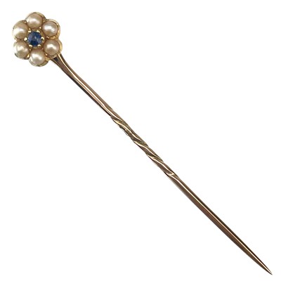 Lot 101 - A gold sapphire and pearl flowerhead stick pin.