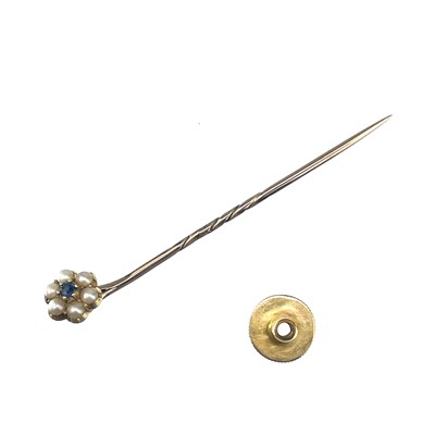 Lot 101 - A gold sapphire and pearl flowerhead stick pin.