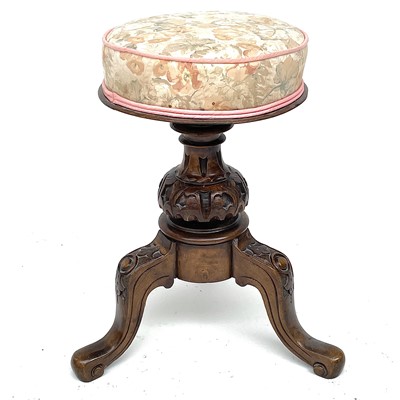 Lot 1810 - A Victorian walnut circular piano stool, with...