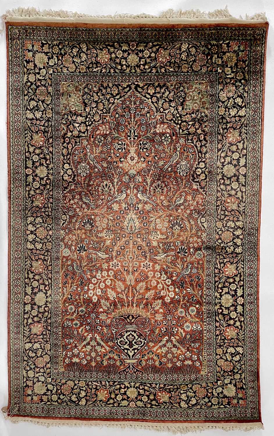 Lot 1202 - An Indian silk rug.