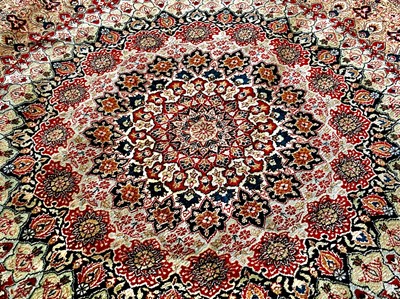 Lot 1206 - A circular silk rug.