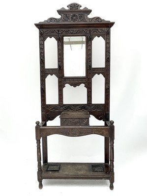 Lot 1895 - A late Victorian carved oak hallstand, fitted...