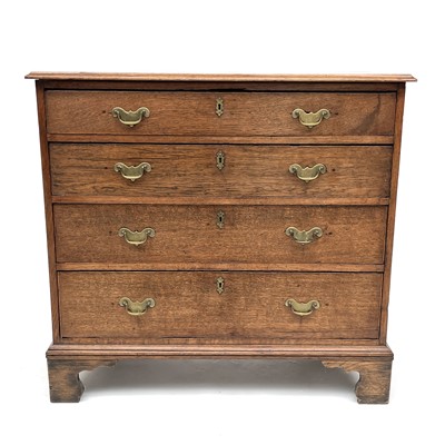 Lot 1900 - A George III oak chest of four long drawers,...