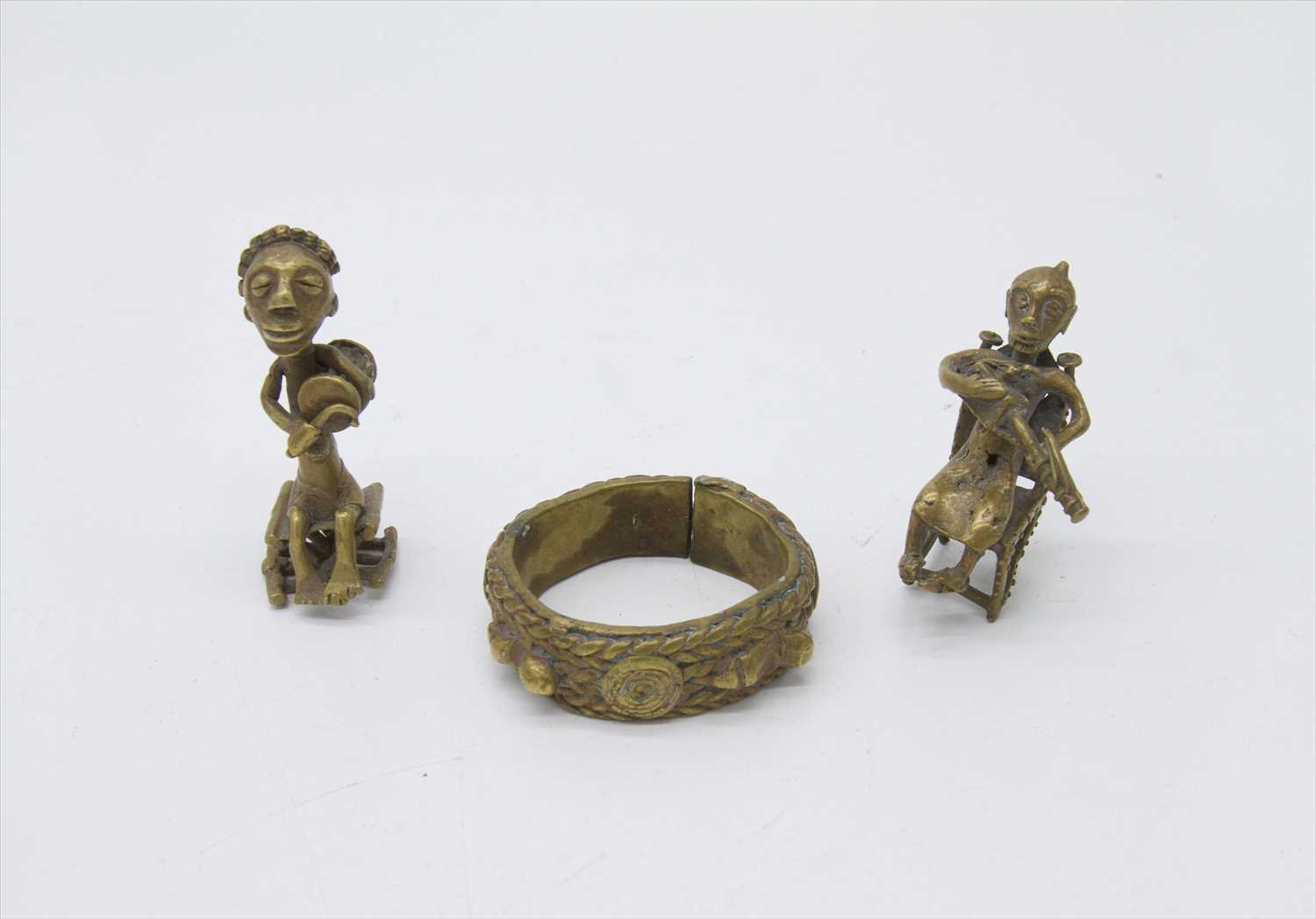 Lot 286 - Two African cast brass figures of musicians,...