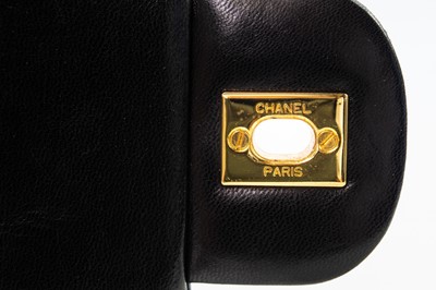 Lot 386 - A Chanel Double Flap handbag in black lambskin with gold tone hardware.