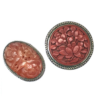 Lot 250 - A Chinese carnelian foliate carved and pierced silver plated metal mounted oval clip brooch.