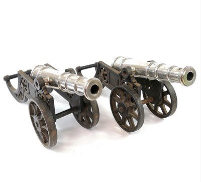 Lot 201 - A pair of model cannons, with silver plated...