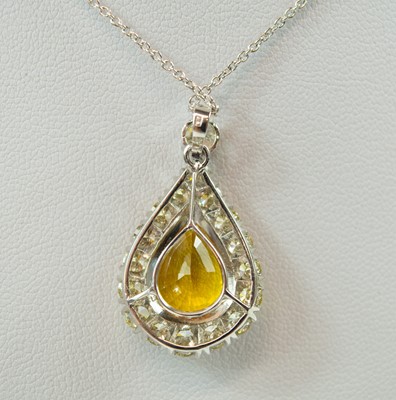 Lot 135 - An 18ct white gold, yellow sapphire and diamond cluster pendant necklace.
