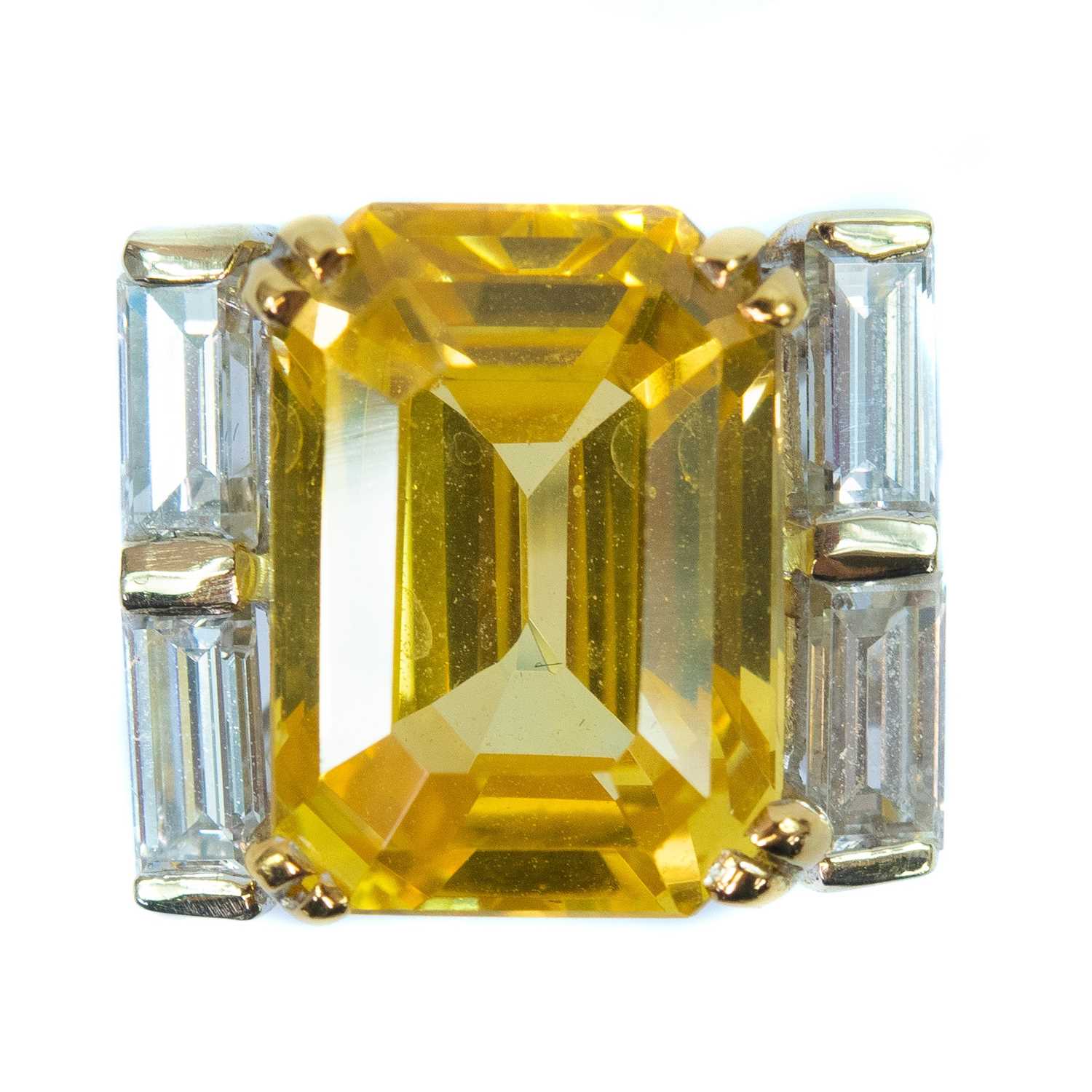 Lot 396 - Boucheron - A yellow sapphire and diamond platinum ring.