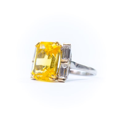 Lot 396 - Boucheron - A yellow sapphire and diamond platinum ring.