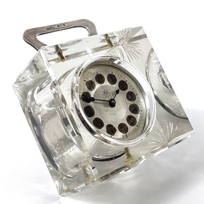 Lot 184 - An Edwardian glass cased timepiece with silver handle.