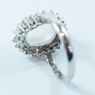 Lot 77 - An 18ct white gold moonstone and diamond cluster ring.