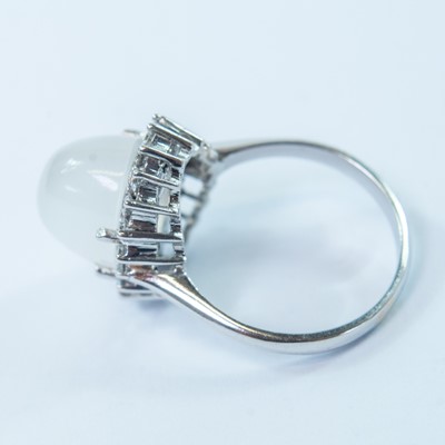 Lot 77 - An 18ct white gold moonstone and diamond cluster ring.