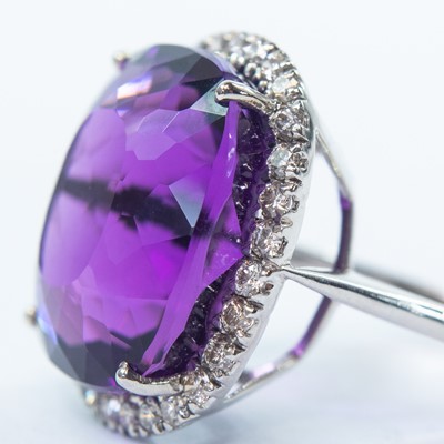 Lot 168 - An 18ct white gold amethyst and diamond cluster dress ring.
