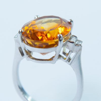 Lot 29 - An 18ct white gold citrine and diamond dress ring.