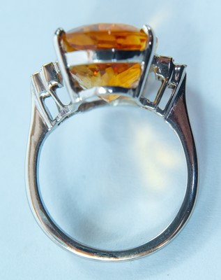 Lot 29 - An 18ct white gold citrine and diamond dress ring.
