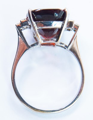 Lot 90 - An 18ct white gold garnet and diamond set dress ring.