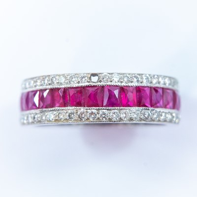 Lot 75 - An 18ct white gold diamond and ruby set full eternity ring.