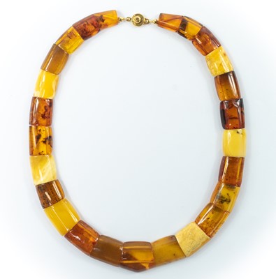 Lot 228 - A contemporary multi-coloured amber panel bead necklace with gold plated button clasp.