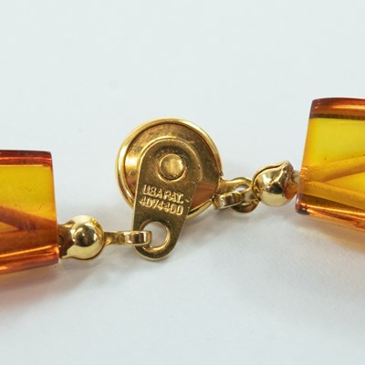 Lot 228 - A contemporary multi-coloured amber panel bead necklace with gold plated button clasp.