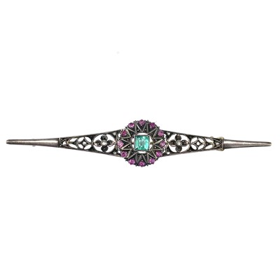 Lot 214 - An Edwardian gold and silver set diamond, emerald and ruby bar brooch.