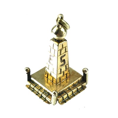 Lot 57 - An 18ct gold charm in the form of an obelisk.