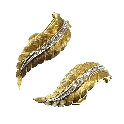 Lot 103 - A pair of 18ct bi-colour gold diamond set leaf design clip earrings.