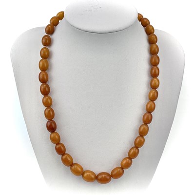 Lot 218 - A butterscotch amber graduated oval bead necklace.