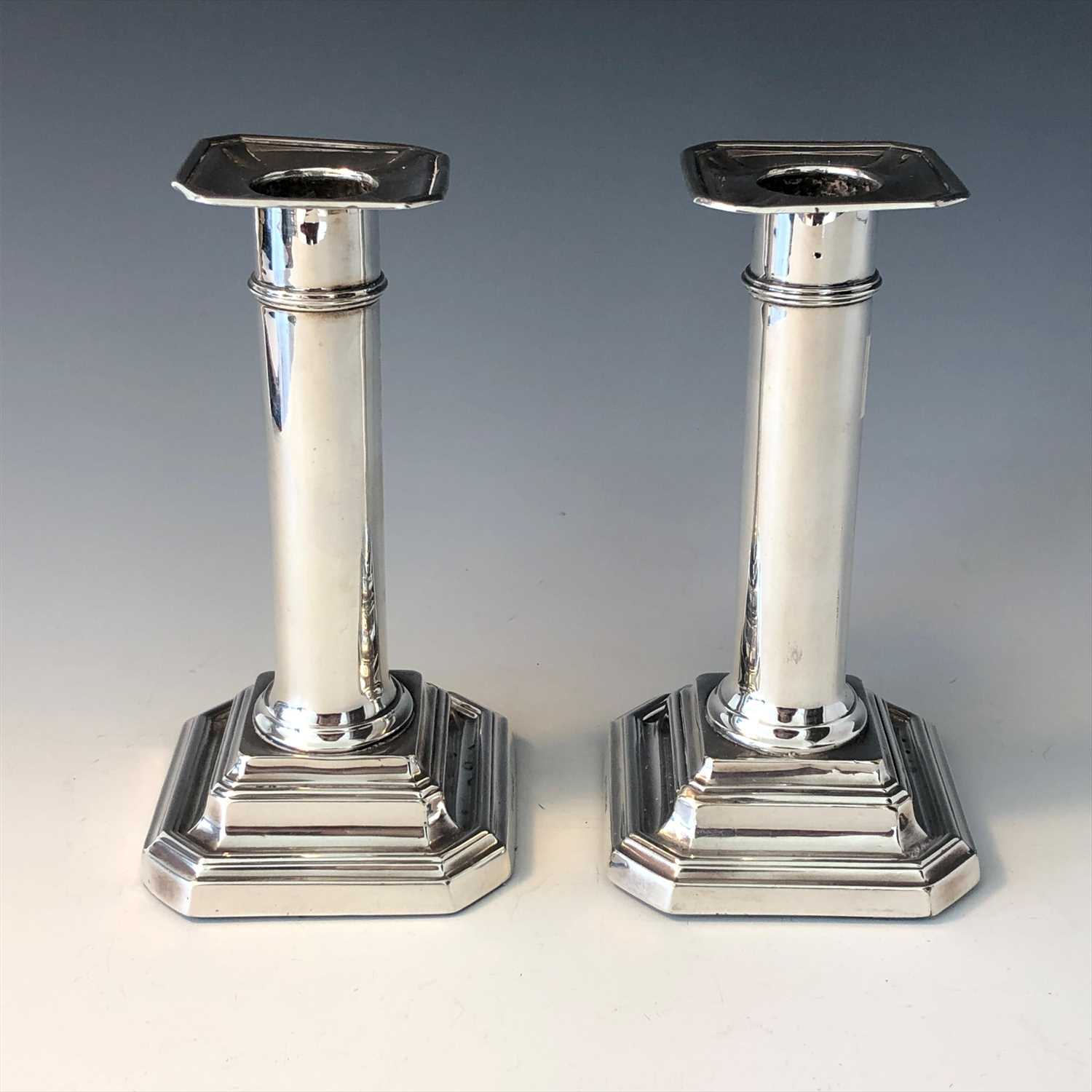 Lot 2069 A pair of silver candlesticks.