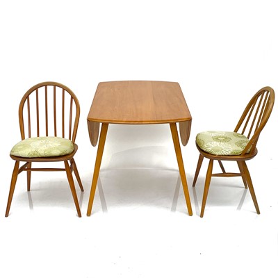 Lot 1898 - An Ercol light elm twin flap dining table.