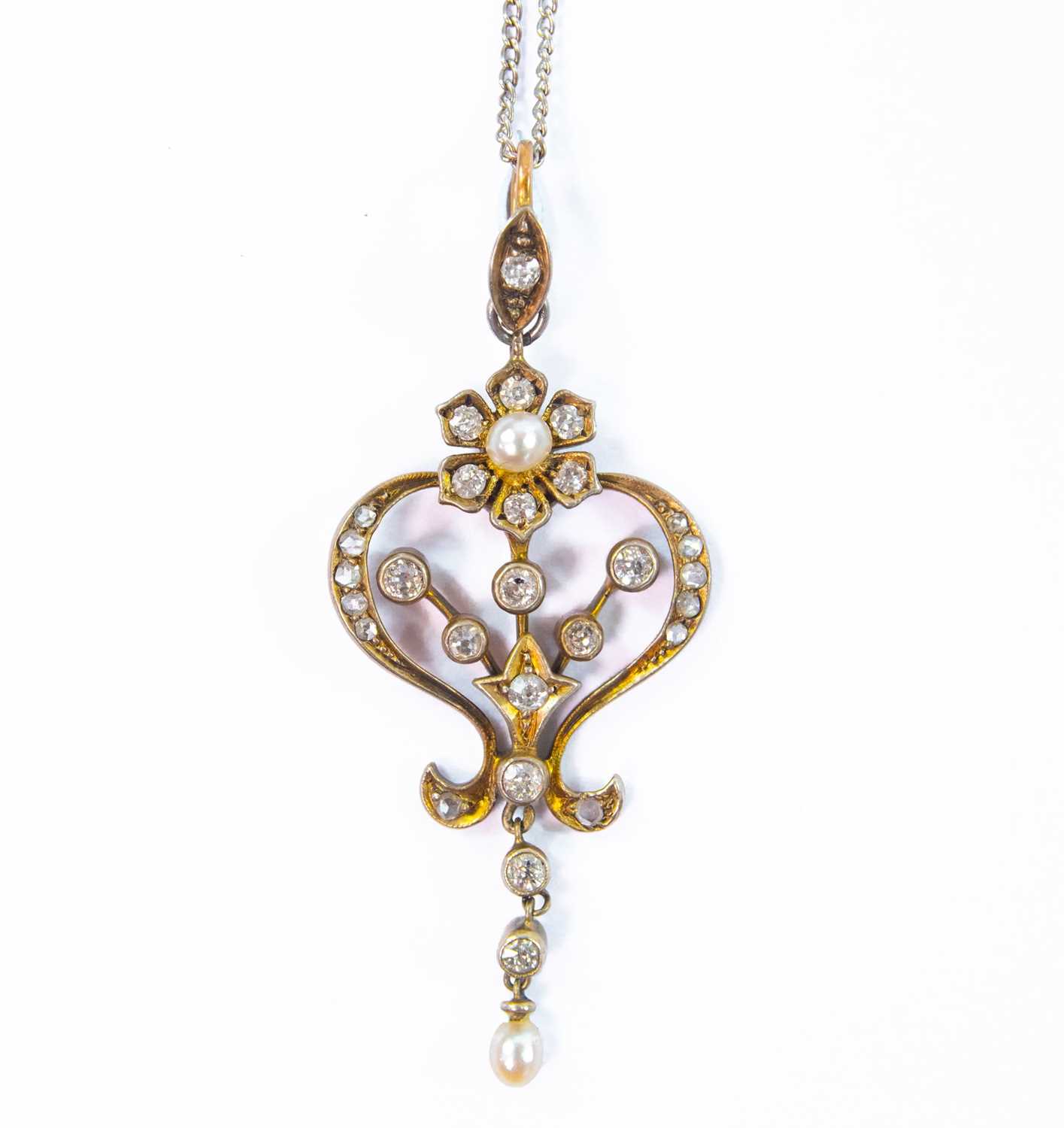 Lot 166 - An Edwardian gold diamond and pearl set openwork pendant.