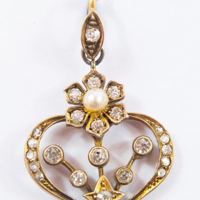 Lot 166 - An Edwardian gold diamond and pearl set openwork pendant.