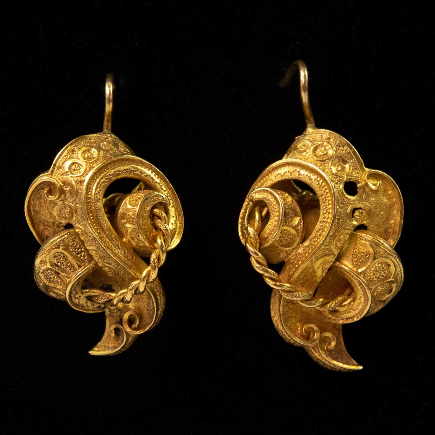 Lot 102 - A pair of Victorian high purity gold scroll shaped openwork earrings.
