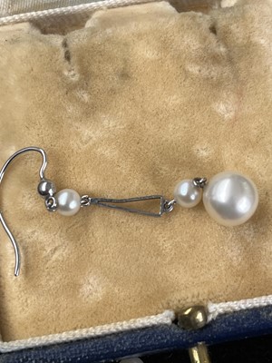 Lot 187 - A pair of early 20th century 9ct white gold and pearl drop earrings.