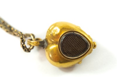 Lot 108 - A Victorian gold carbuncle garnet set heart shaped pendant locket and chain.