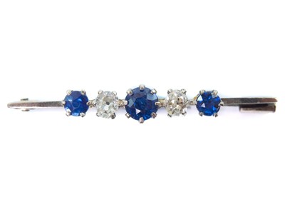 Lot 172 - An 18ct white gold diamond and sapphire set five stone bar brooch.