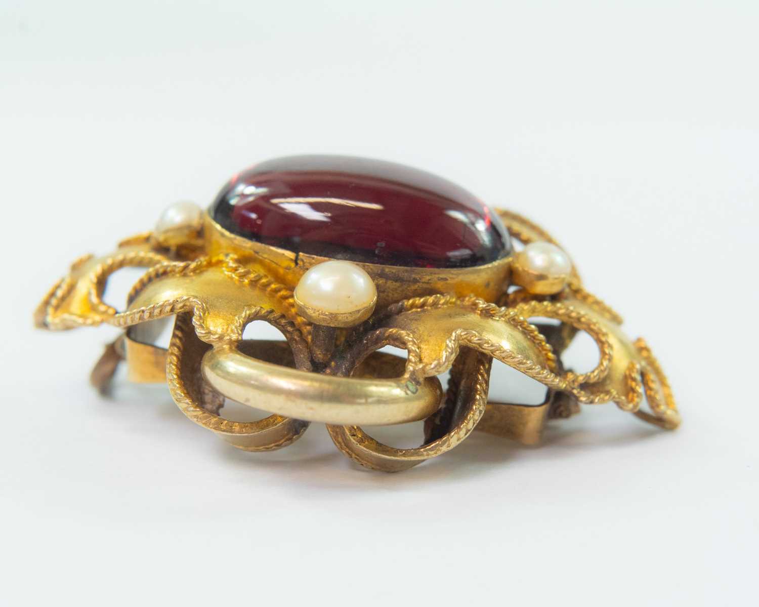 Lot 64 - A Victorian gold carbuncle brooch.
