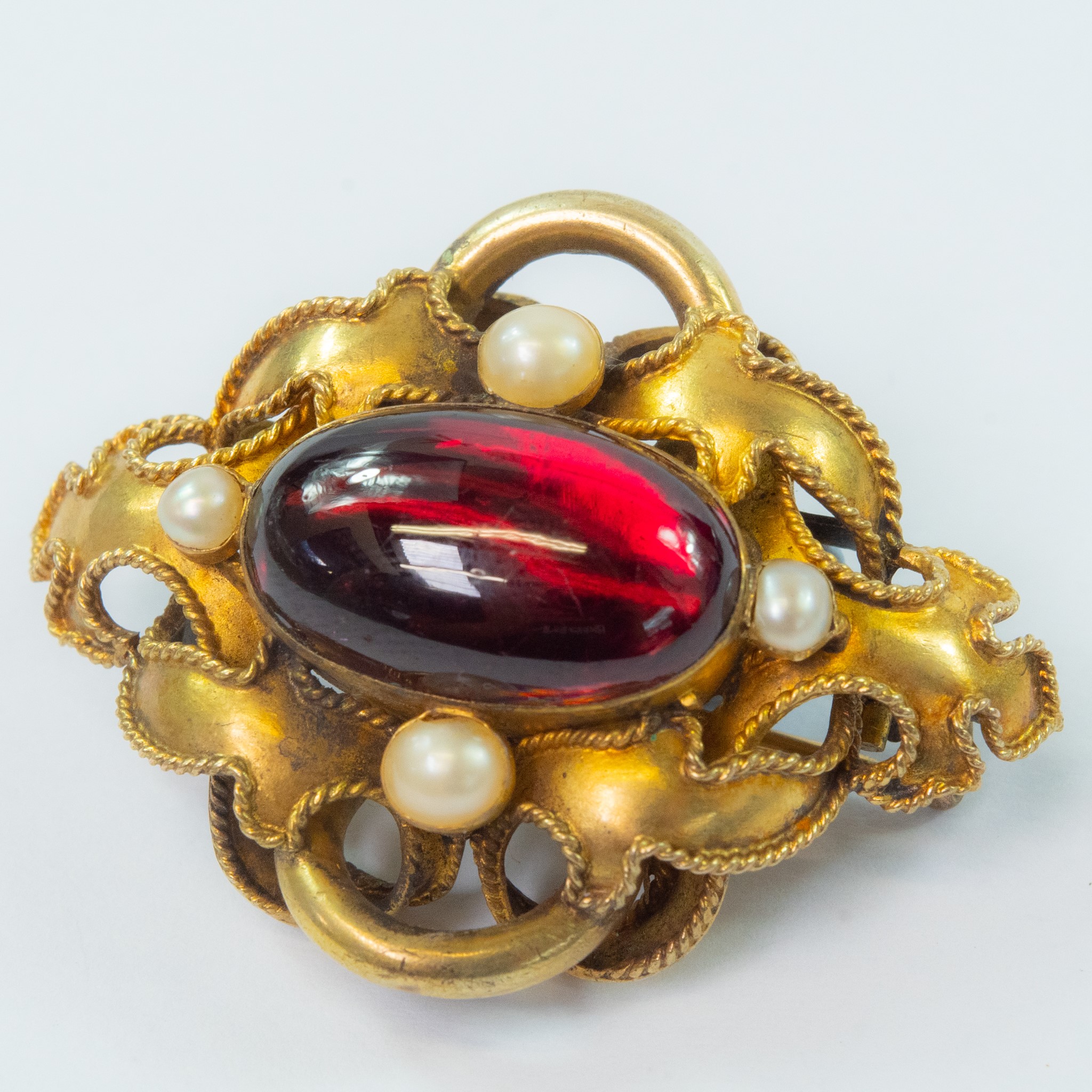 Lot 64 - A Victorian gold carbuncle brooch.