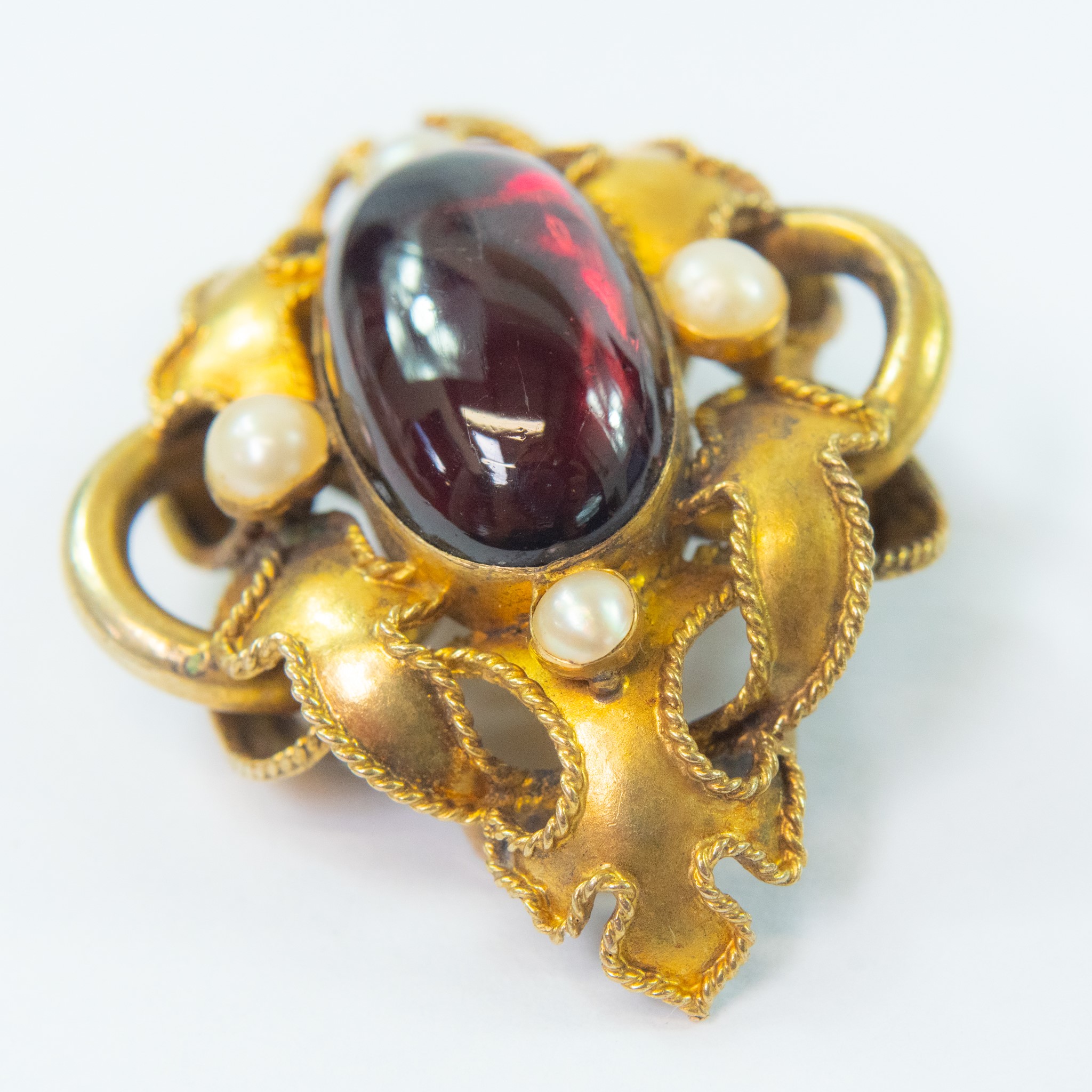 Lot 64 - A Victorian gold carbuncle brooch.