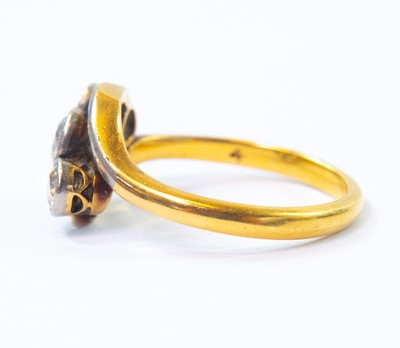 Lot 8 - An 18ct gold three stone diamond cross-over ring