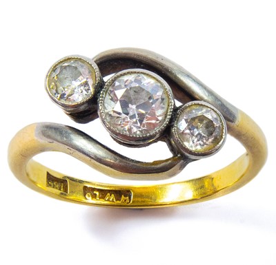 Lot 8 - An 18ct gold three stone diamond cross-over ring